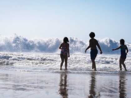 Three people on the beach