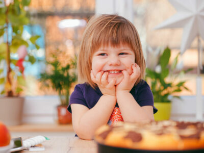 Girl sitting at a table with food