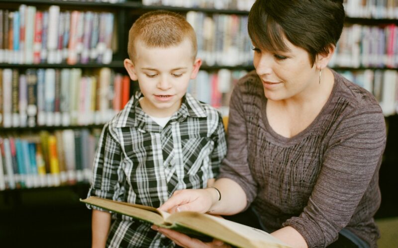 a adult reading a book with a child