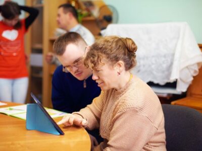 two people watching digital tablet