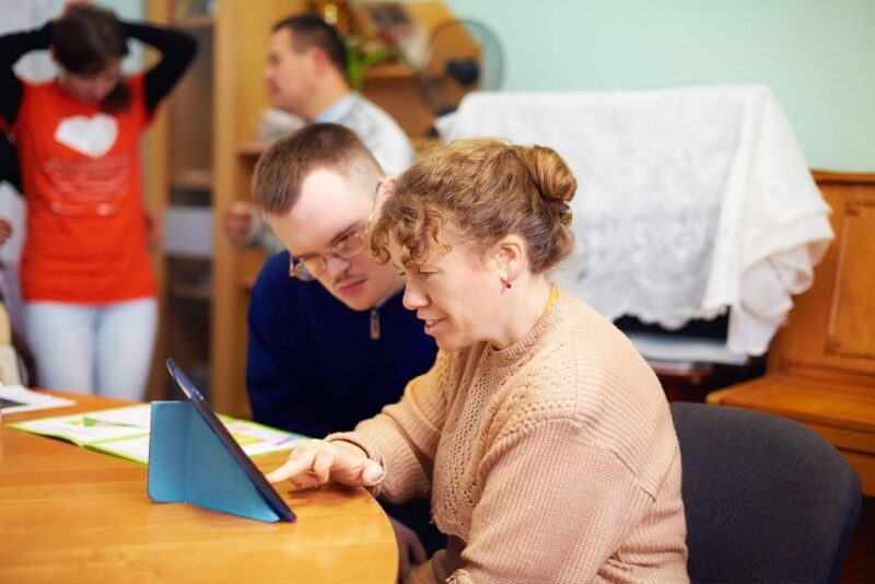 two people watching digital tablet