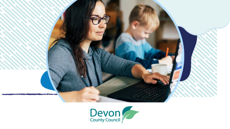 A woman at home on a laptop with a young boy next to her. There's a Devon County Council logo at the bottom