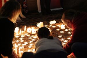 People sat looking at a display of candles