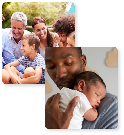 man hugging a baby and a group of adults and chidren sitting in a park