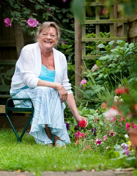 happy women smiling in her garden