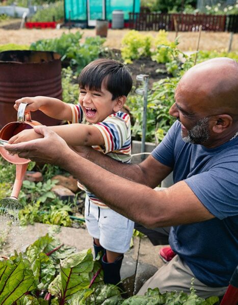 man and child smiling in the garden