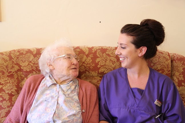 Ashleigh sitting on sofa with client