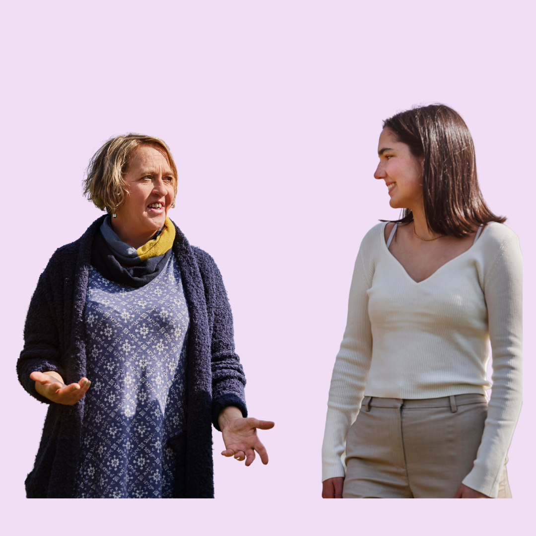 The image shows two people talking while walking in a park setting.